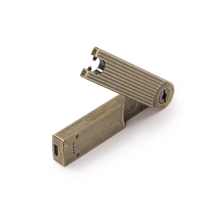 Brushed gold arc lighter with striped grip, side key slot, and screw details