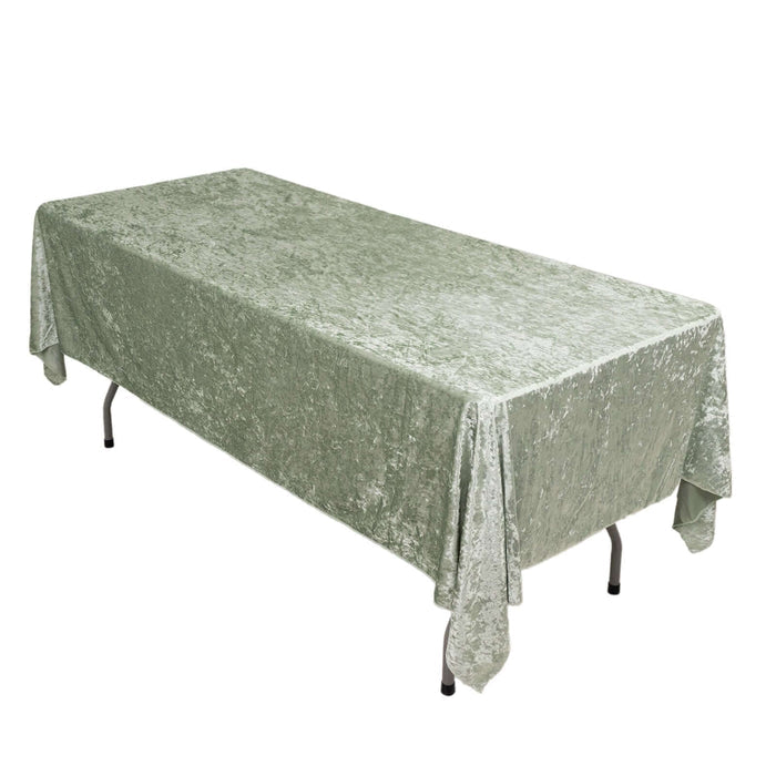 Green velvet tablecloth draped over a rectangular table