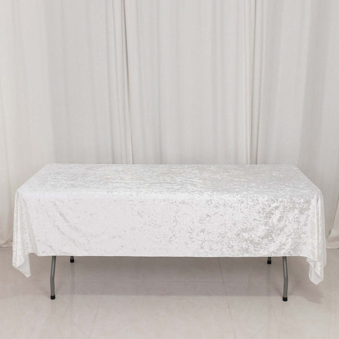 White sequin tablecloth draped over a folding table in a studio setting.