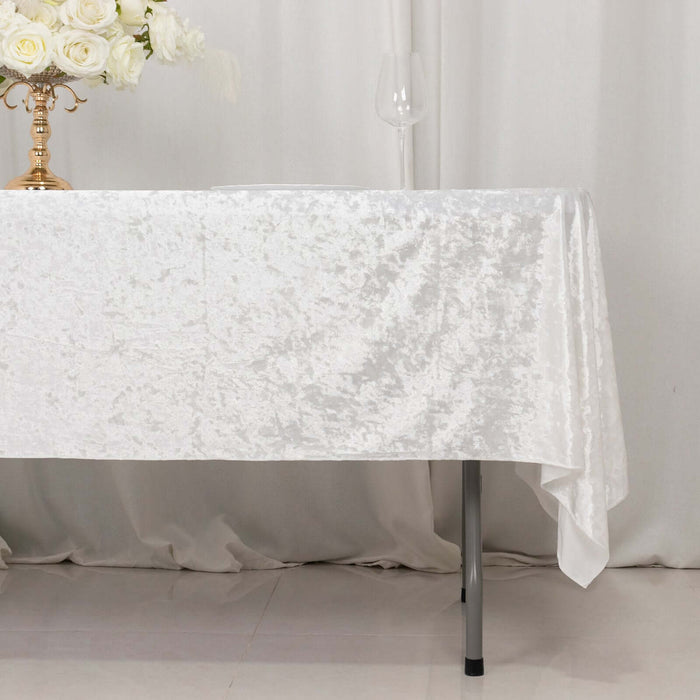White textured tablecloth draping over a table with floral centerpiece