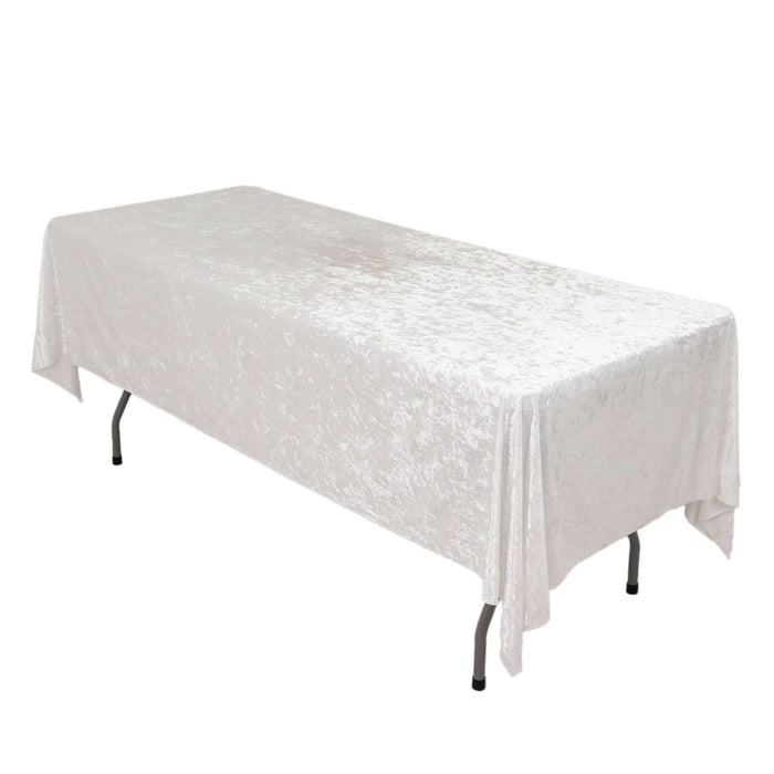 White tablecloth draped over a folding table in a studio setting.