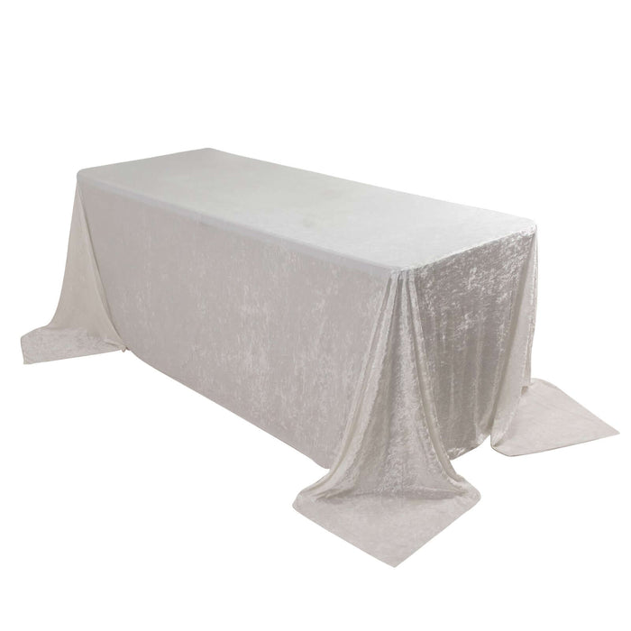 Silver velvet tablecloth on rectangular table, elegantly draped.