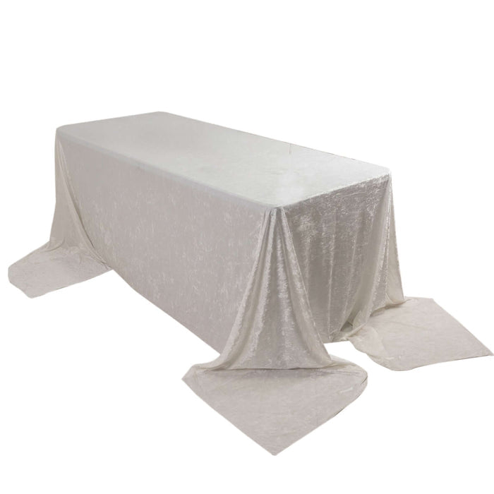 Rectangular table covered with a shimmering silver tablecloth.
