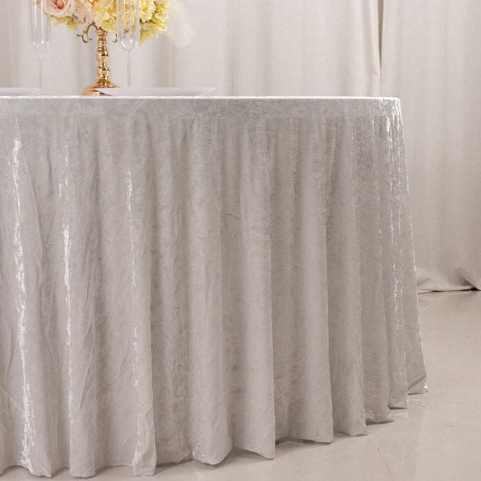 Elegant silver tablecloth draping over a round table.