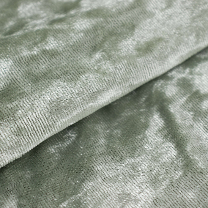 Soft green textured fabric with a shimmering finish.