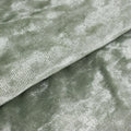 Soft green textured fabric with a shimmering finish.