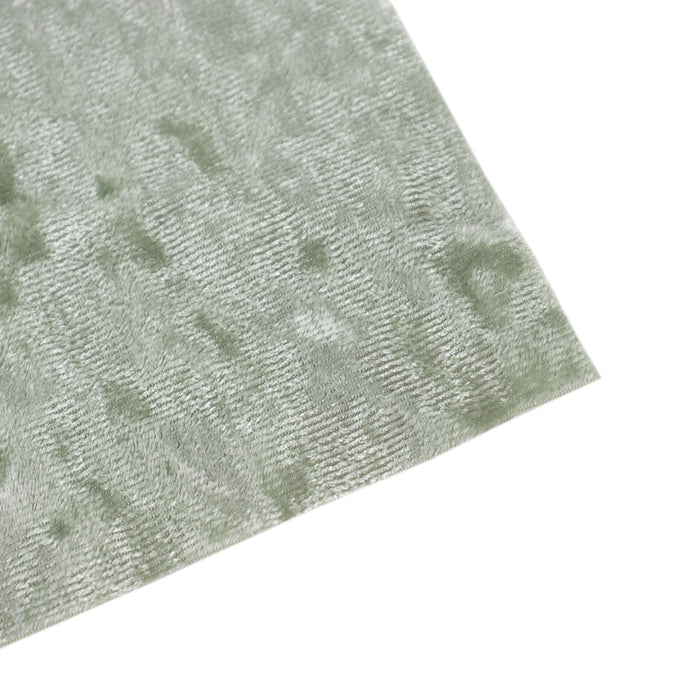 Textured green fabric swatch on a white background.