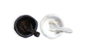 Handmade salt and pepper set with dark and light ceramic bowls plus matching serving spoons