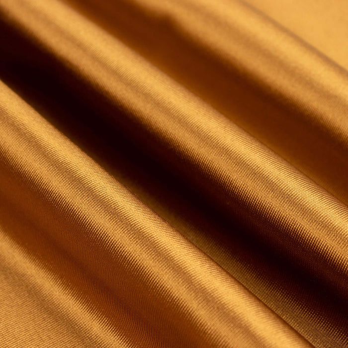 Close-up of rich golden fabric showcasing smooth texture and sheen.