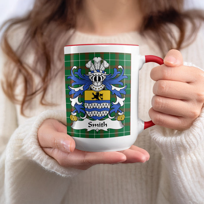 White mug with red handle displaying Smith family crest on tartan background.