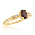 Gold-overlay ring with an oval smoky quartz center and clear accent stones