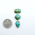 Sonoran Mountain Turquoise cabochons, blue-green color with natural matrix, polished stones on a white background, with a US dime for scale