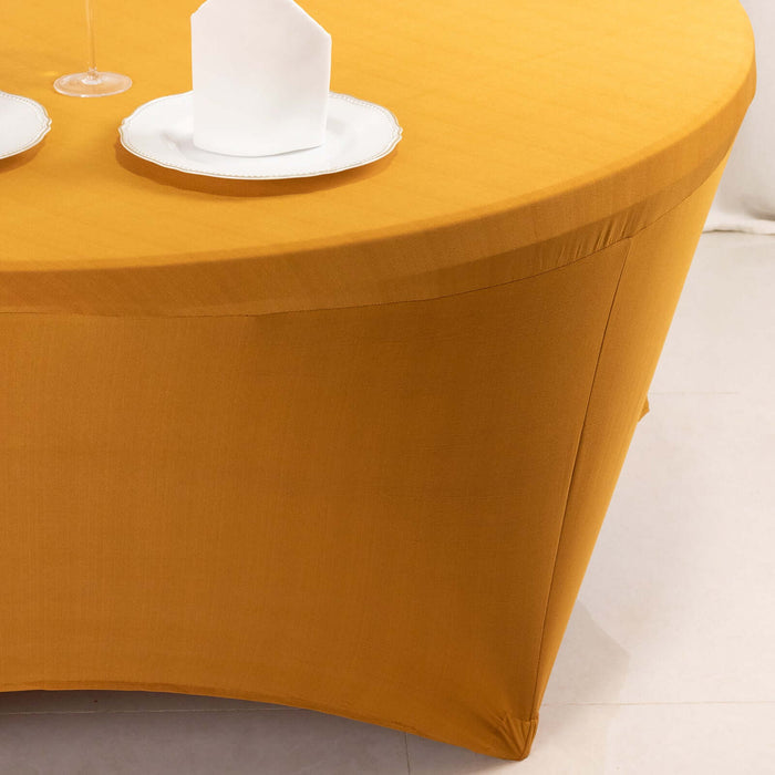 Yellow tablecloth draped over a round table with white plates and napkins.