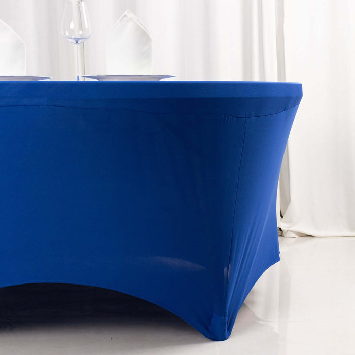 Blue fitted tablecloth on a round table in a styled setting.