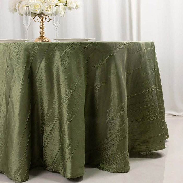 Olive green tablecloth with a textured finish on a table.