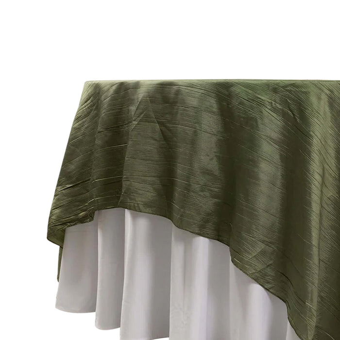 Olive green tablecloth draped elegantly over a white table.