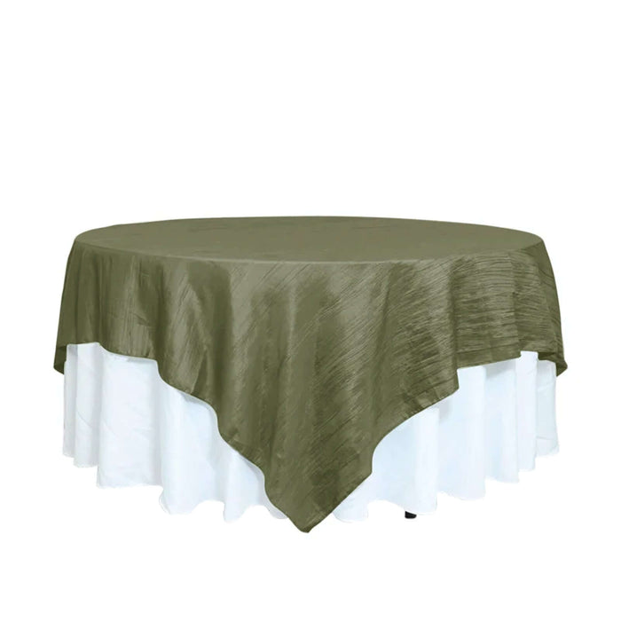 Olive green round tablecloth on a white table