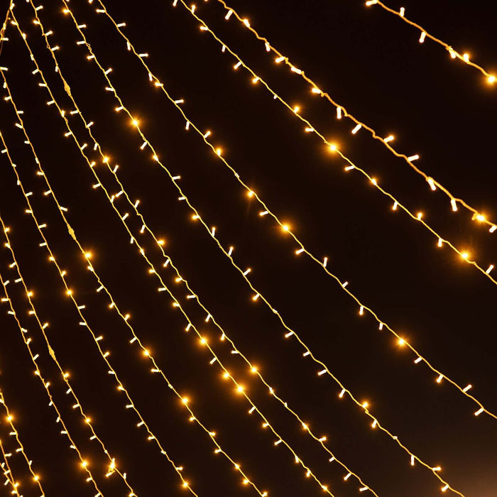 Warm white string lights glowing against a dark backdrop.