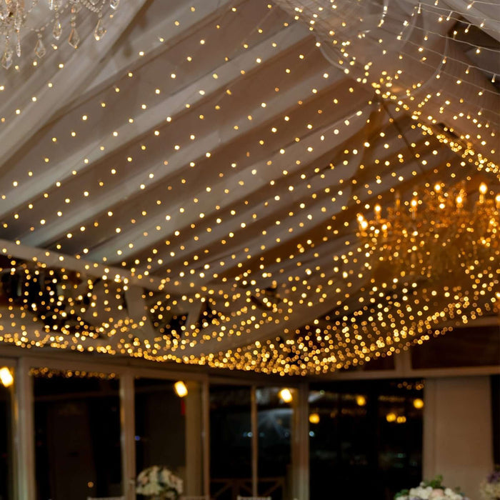 Festive string lights illuminating a beautifully decorated event space.