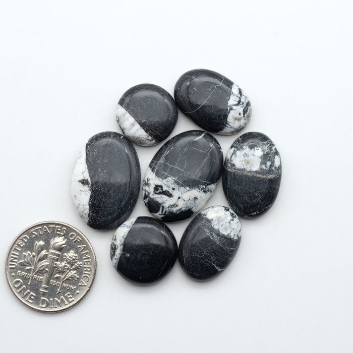 Natural White Buffalo Stone Cabochons are semi-precious gemstones cut into shapes ideal for jewelry-making, making them an excellent choice for artisans.